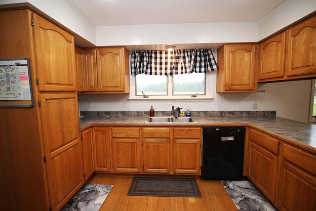 53240 Hemlock Lake Rd, Marcellus, MI 49067 - kitchen featuring dishwasher, a sink, dark countertops, and brown cabinetry