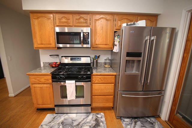 53240 Hemlock Lake Rd, Marcellus, MI 49067 - kitchen with stainless steel appliances, light wood-style floors, and baseboards