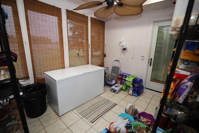 53240 Hemlock Lake Rd, Marcellus, MI 49067 - laundry area featuring light tile patterned flooring, ceiling fan, and wooden walls