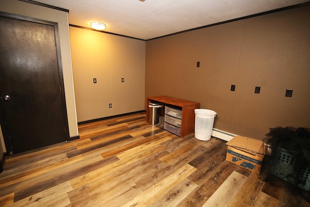 53240 Hemlock Lake Rd, Marcellus, MI 49067 - unfurnished room with a baseboard radiator, crown molding, and wood finished floors