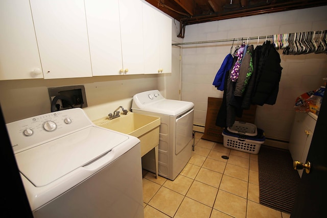 53240 Hemlock Lake Rd, Marcellus, MI 49067 - laundry room featuring washer and dryer, cabinet space, a baseboard heating unit, and light tile patterned floors