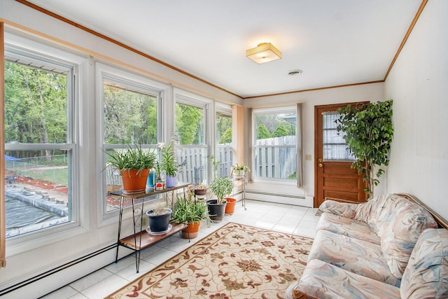 sunroom with crown molding, a wealth of natural light, baseboard heating, and tile patterned flooring
