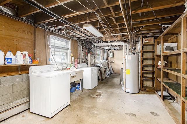 basement featuring washer and clothes dryer, a sink, and gas water heater