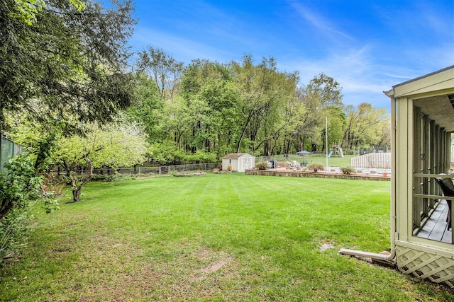 view of yard with a storage shed, an outdoor structure, and a fenced backyard