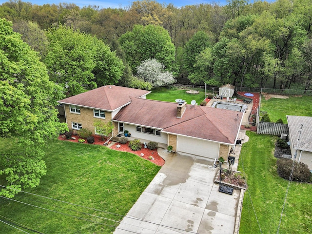 drone / aerial view featuring a wooded view