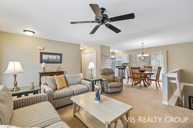 living room featuring ceiling fan with notable chandelier and light colored carpet