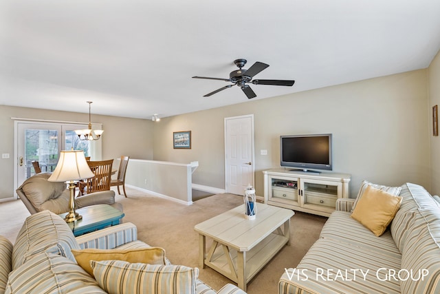 living room with baseboards, carpet flooring, and ceiling fan with notable chandelier
