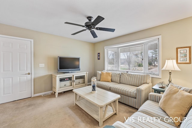 living room with light colored carpet, baseboards, ceiling fan, and visible vents
