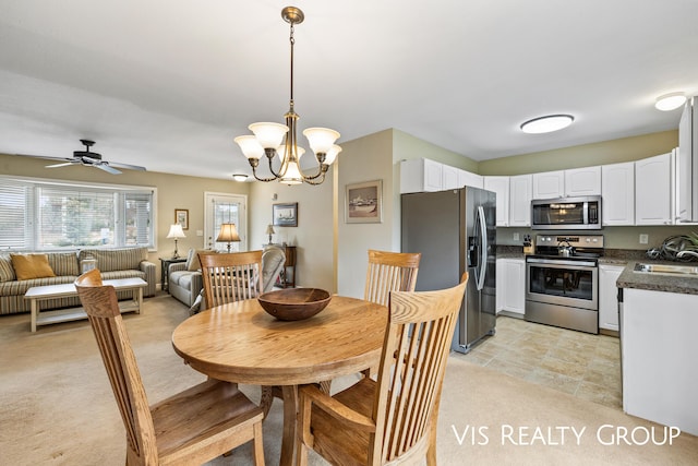 dining space with light carpet and ceiling fan with notable chandelier