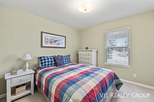 carpeted bedroom with baseboards
