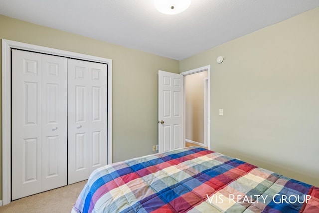 carpeted bedroom featuring a closet