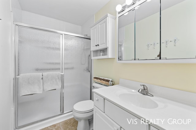 full bathroom with vanity, toilet, tile patterned flooring, and a stall shower