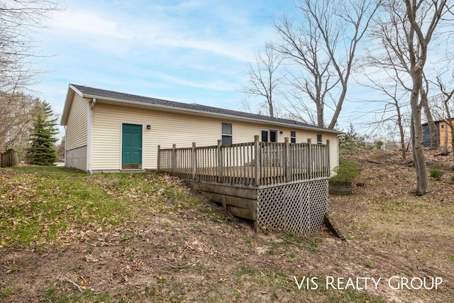 rear view of property featuring a wooden deck