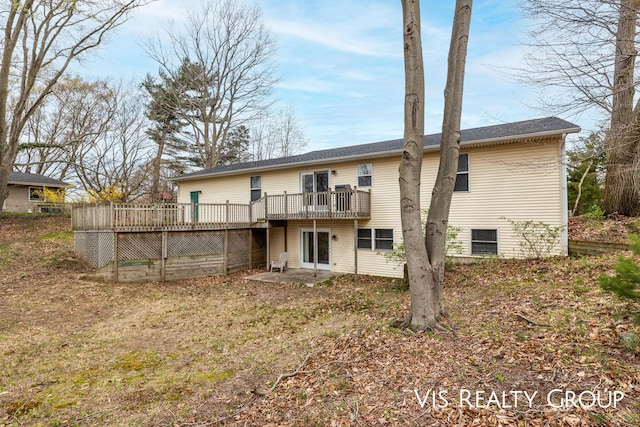 back of property featuring a wooden deck