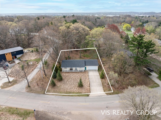 birds eye view of property with a forest view