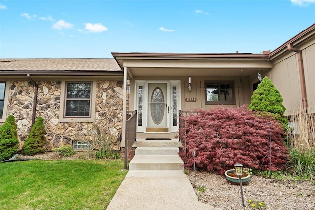 11771 Shenandoah Dr, Green Oak Twp, MI 48178 - doorway to property with stone siding, a shingled roof, and a lawn