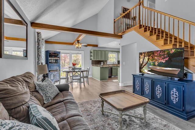 109 Diversy Dr, Brooklyn, MI 49230 - living area featuring stairway, high vaulted ceiling, a ceiling fan, and light wood-type flooring