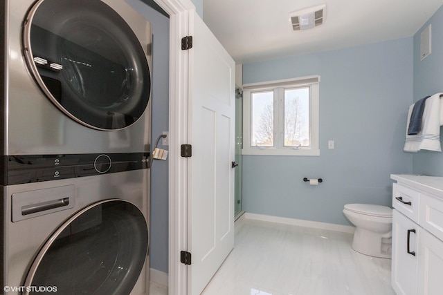 257 Shoreview Way Unit 9, Saint Joseph, MI 49085 - washroom featuring stacked washing machine and dryer, baseboards, and light marble finish floors