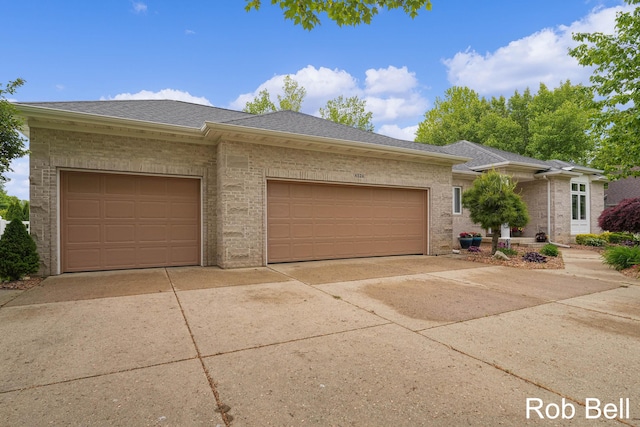 4524 Hidden Ridge Dr, Hudsonville, MI 49426 - view of front of home featuring concrete driveway, an attached garage, roof with shingles, and brick siding