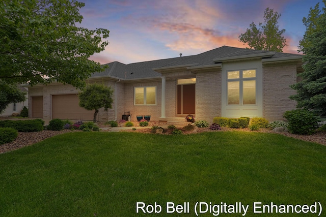 4524 Hidden Ridge Dr, Hudsonville, MI 49426 - view of front of home with a front lawn, an attached garage, brick siding, and a shingled roof