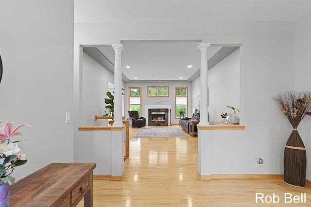 4524 Hidden Ridge Dr, Hudsonville, MI 49426 - hallway featuring ornate columns, light wood-style flooring, recessed lighting, and baseboards
