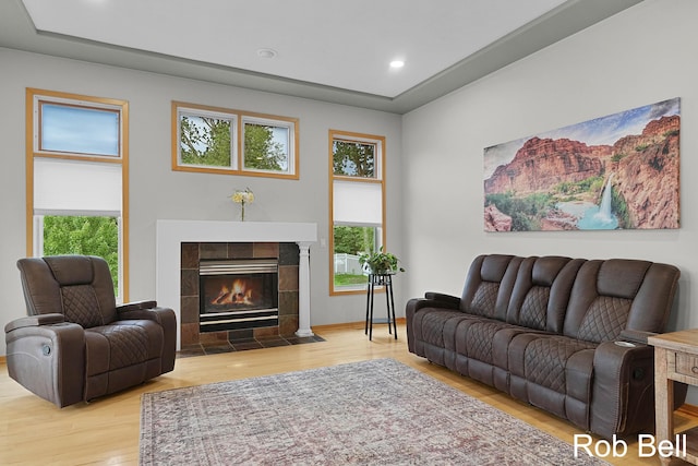 4524 Hidden Ridge Dr, Hudsonville, MI 49426 - living room featuring wood finished floors, healthy amount of natural light, a tiled fireplace, and recessed lighting