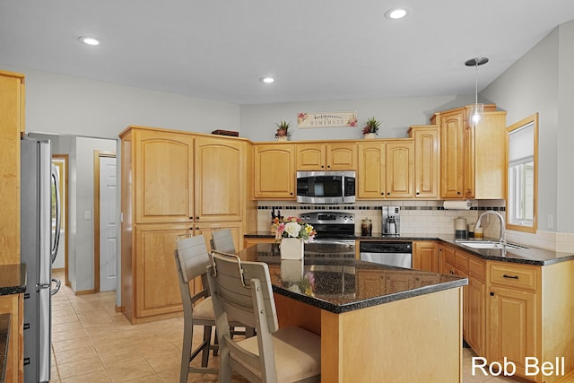 4524 Hidden Ridge Dr, Hudsonville, MI 49426 - kitchen featuring appliances with stainless steel finishes, a sink, tasteful backsplash, a kitchen breakfast bar, and dark stone countertops