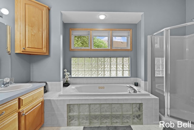 4524 Hidden Ridge Dr, Hudsonville, MI 49426 - bathroom with vanity, a shower stall, and a garden tub