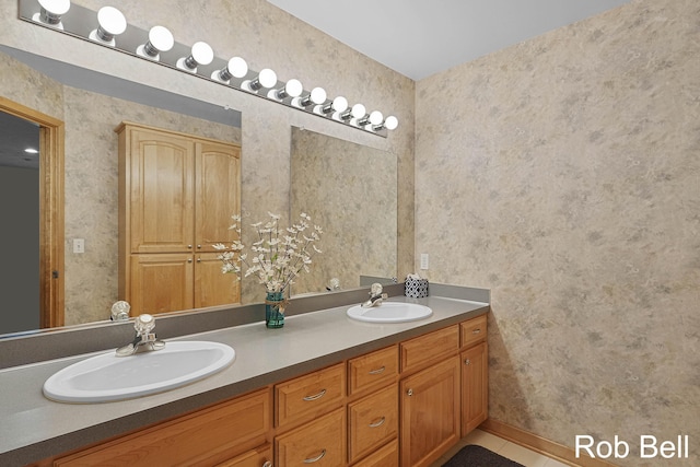 4524 Hidden Ridge Dr, Hudsonville, MI 49426 - bathroom with wallpapered walls, double vanity, baseboards, and tile patterned flooring