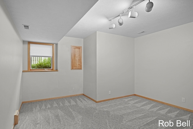 4524 Hidden Ridge Dr, Hudsonville, MI 49426 - carpeted empty room featuring baseboards, a textured ceiling, and rail lighting