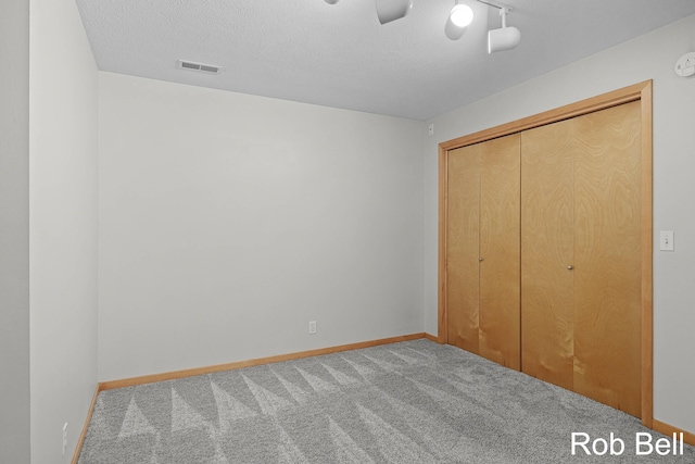 4524 Hidden Ridge Dr, Hudsonville, MI 49426 - unfurnished bedroom with carpet flooring, baseboards, a closet, a ceiling fan, and a textured ceiling