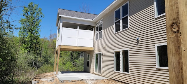 5416 Albright Ave SW Unit 39, Wyoming, MI 49418 - view of side of property featuring a patio area and roof with shingles
