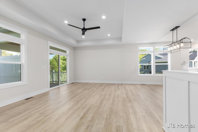 5416 Albright Ave SW Unit 39, Wyoming, MI 49418 - unfurnished living room with a ceiling fan, light wood-type flooring, plenty of natural light, a tray ceiling, and recessed lighting
