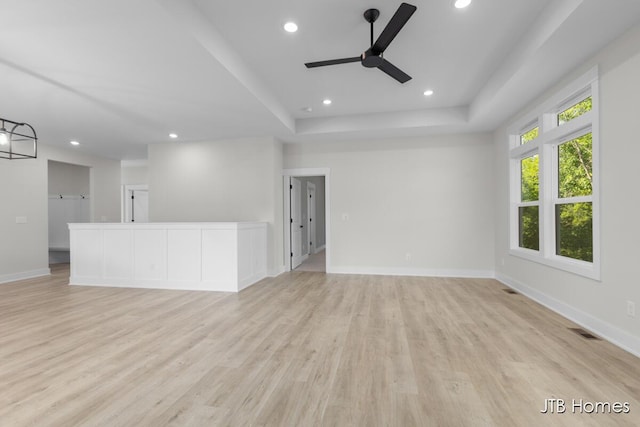 5416 Albright Ave SW Unit 39, Wyoming, MI 49418 - unfurnished living room featuring a ceiling fan, light wood-type flooring, recessed lighting, and a raised ceiling
