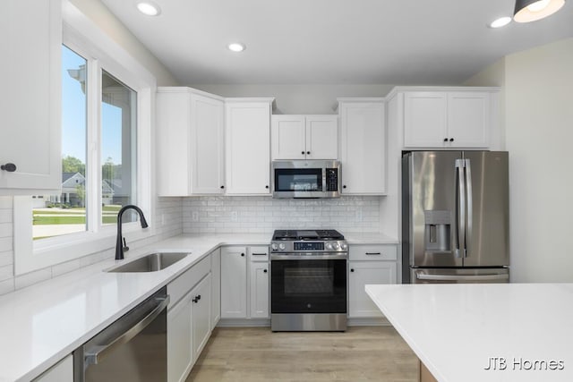 5416 Albright Ave SW Unit 39, Wyoming, MI 49418 - kitchen with stainless steel appliances, light countertops, white cabinetry, backsplash, and recessed lighting