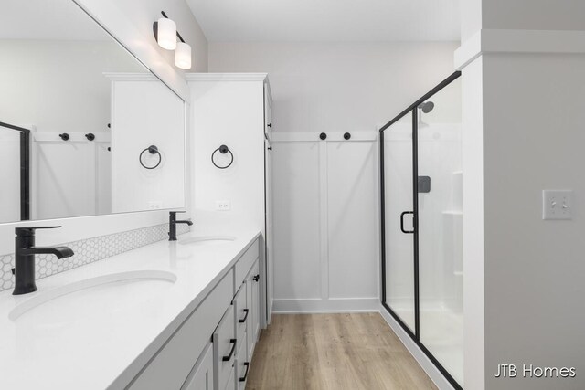 5416 Albright Ave SW Unit 39, Wyoming, MI 49418 - full bathroom with wood finished floors, a stall shower, and double vanity
