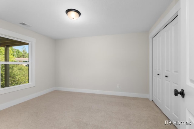 5416 Albright Ave SW Unit 39, Wyoming, MI 49418 - unfurnished bedroom featuring light carpet and a closet