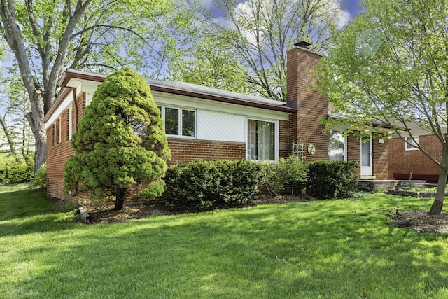1620 Whittier Rd, Ypsilanti, MI 48197 - view of front of house with a chimney, brick siding, and a front lawn