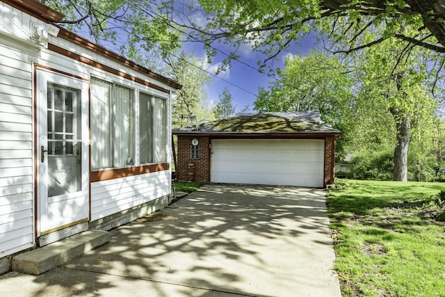1620 Whittier Rd, Ypsilanti, MI 48197 - view of property exterior featuring an outbuilding, a garage, brick siding, and driveway