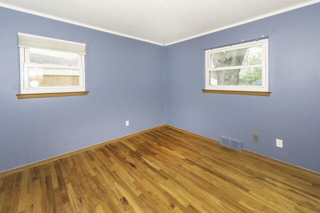 1620 Whittier Rd, Ypsilanti, MI 48197 - empty room with wood finished floors, crown molding, and baseboards