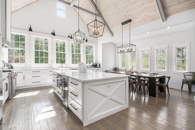 16220 Stones Throw Ln, Union Pier, MI 49129 - kitchen with light countertops, high vaulted ceiling, a chandelier, a center island, and high end range