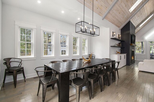 16220 Stones Throw Ln, Union Pier, MI 49129 - dining room with beam ceiling, baseboards, recessed lighting, light wood-type flooring, and a chandelier