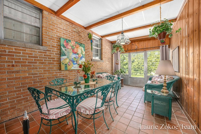 347 Dewitt Ln, Spring Lake, MI 49456 - dining room with beam ceiling, wood walls, tile patterned floors, and brick wall