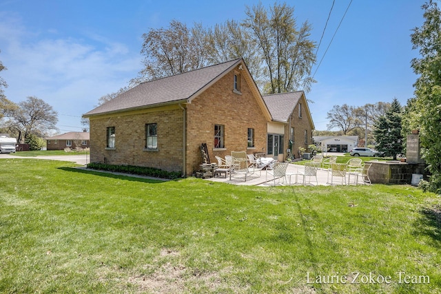 347 Dewitt Ln, Spring Lake, MI 49456 - rear view of house with brick siding, a patio, a yard, and a shingled roof