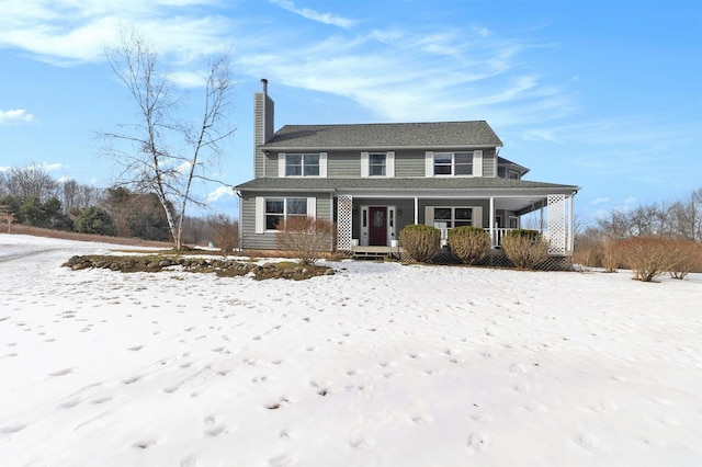 view of front of house with covered porch and a chimney