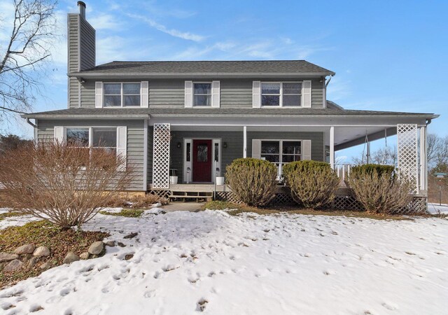 view of front of property with covered porch and a chimney