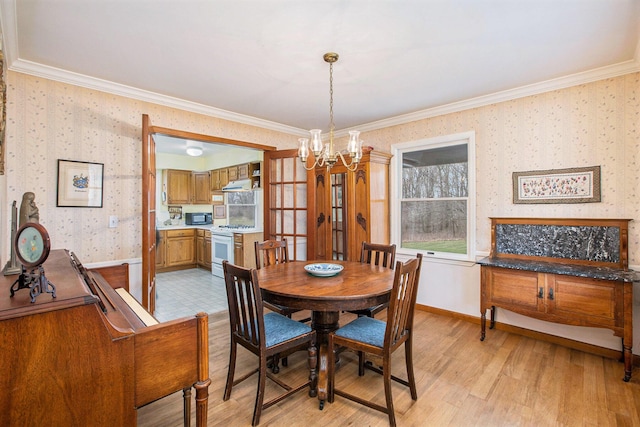 dining room with crown molding, wallpapered walls, and a notable chandelier