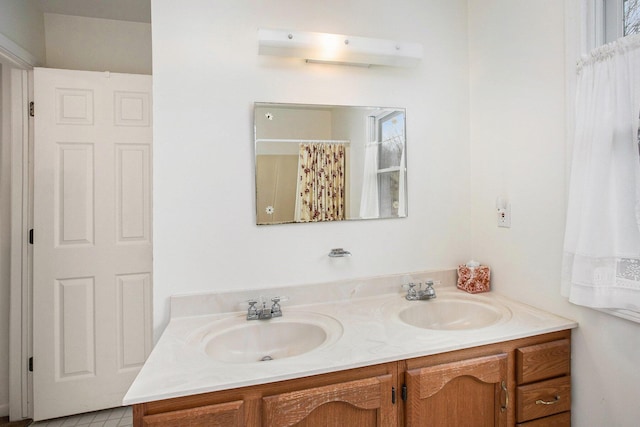 full bathroom featuring double vanity and a sink