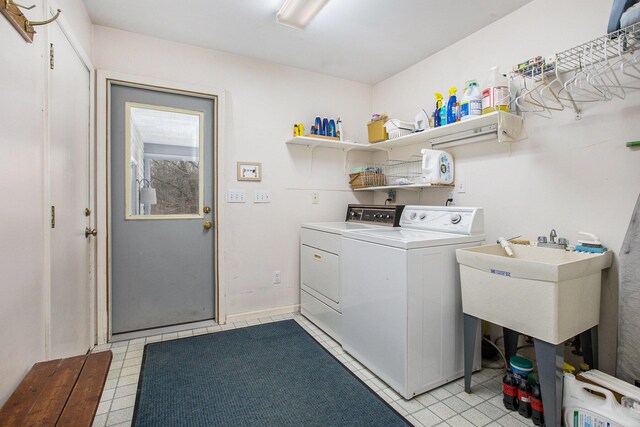 laundry area featuring a sink, separate washer and dryer, and laundry area
