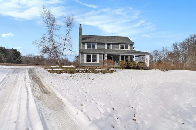 view of front of property featuring a porch and a chimney